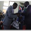 prof.ogechi handing over a present to h.e. governor mandago during the launch